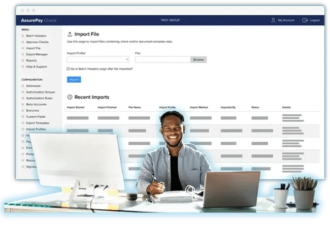 Man with blue glow around him sitting at desk and in front of AssurePay Check software